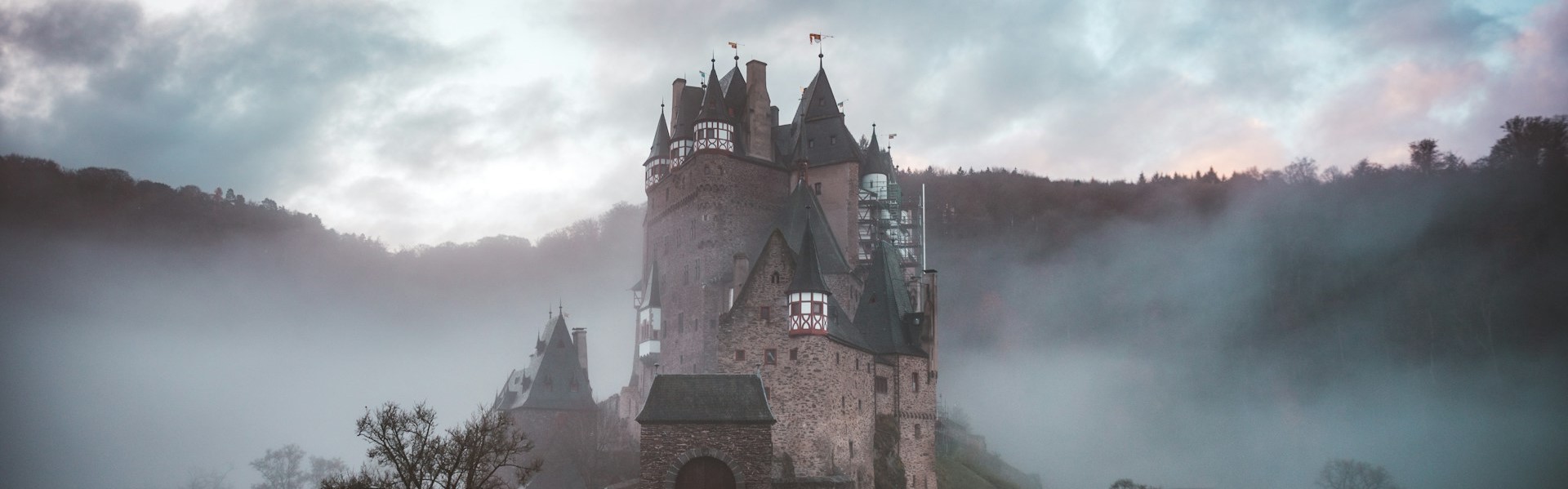 A photo of an old castle surrounded by fog